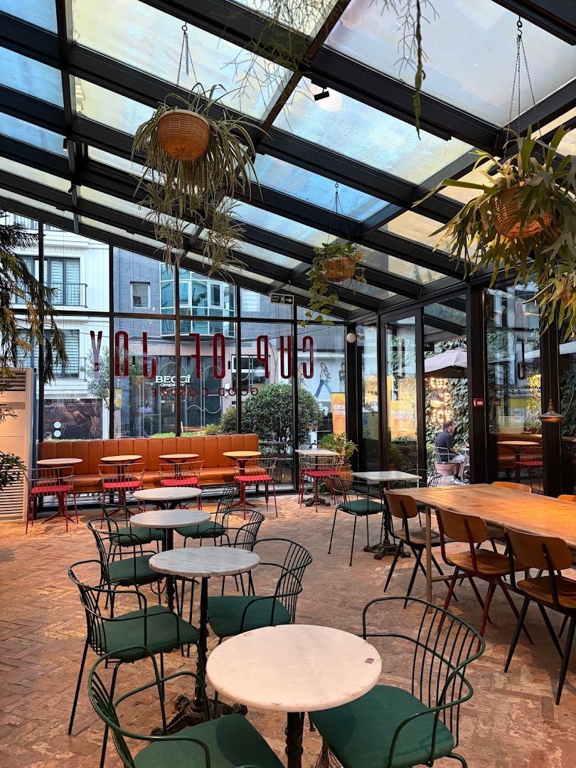 The glass-roofed dining area at Cup of Joy Nişantaşı
